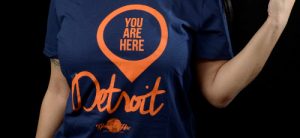 Close up photo of woman wearing blue You are here Detroit t-shirt