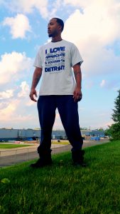 Man standing on lawn wearing white I love where I'm from t-shirt